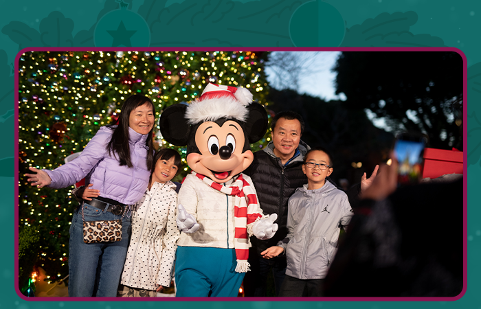 Family with Mickey Mouse in front of Christmas Tree