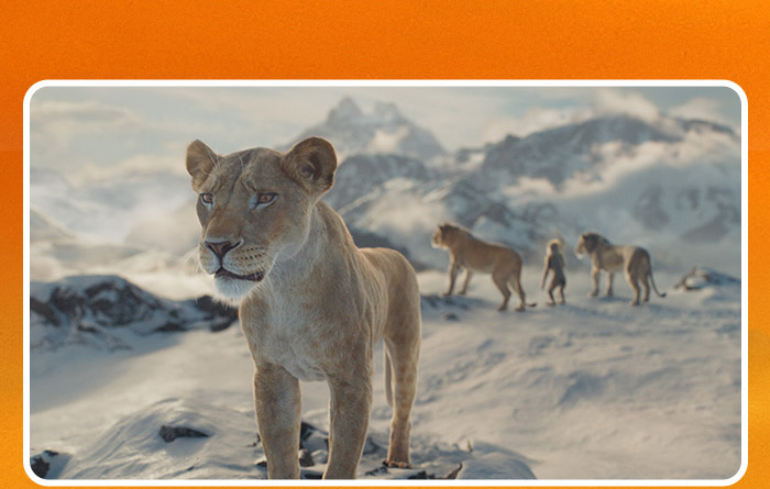 On a snowy mountaintop, Sarabi (voiced by Tiffany Boone), is staring forward, looking concerned.  Behind at a distance, Mufasa (voiced by Aaron Pierre), Rafiki (voiced by Kagiso Lediga), and Taka (voiced by Kelvin Harrison Jr.) in Disney's live-action Mufasa: The Lion King. 