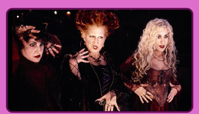 Sanderson sisters—Winifred, Mary, and Sarah—from Hocus Pocus posing together in dark costumes.