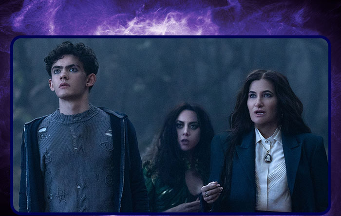 In a scene from Agatha All Along, (from left to right), Teen (Joe Locke), The Green Witch/Rio Vidal (Aubrey Plaza), and Agatha Harkness (Kathryn Hahn) standing together in a dark, foggy forest.