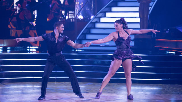 An image featuring Dancing With The Stars couple in mid-performance.