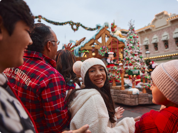 A crowd at Disneyland enjoying the Christmas parade