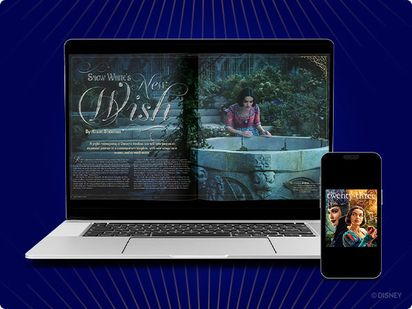 A laptop screen displaying a digital article titled, 'Snow White's New Wish,' with Snow White leaning over a stone wishing well. Beside the laptop, a smartphone screen shows the cover of Disney Twenty-Three magazine with Snow White and the Evil Queen.