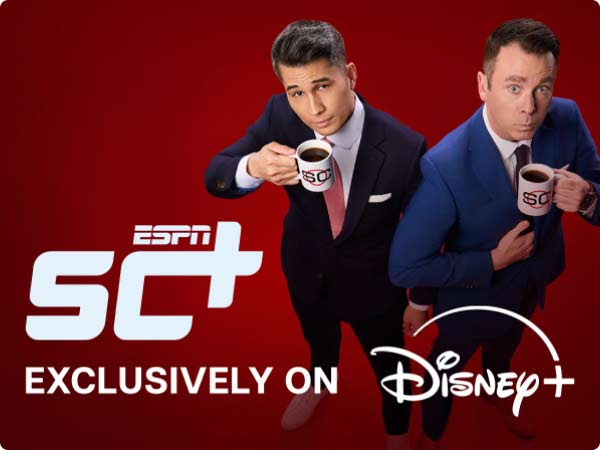 ESPN SC+ exclusively on Disney Plus. Two sports analysts in suits sip coffee, promoting the new ESPN streaming show.