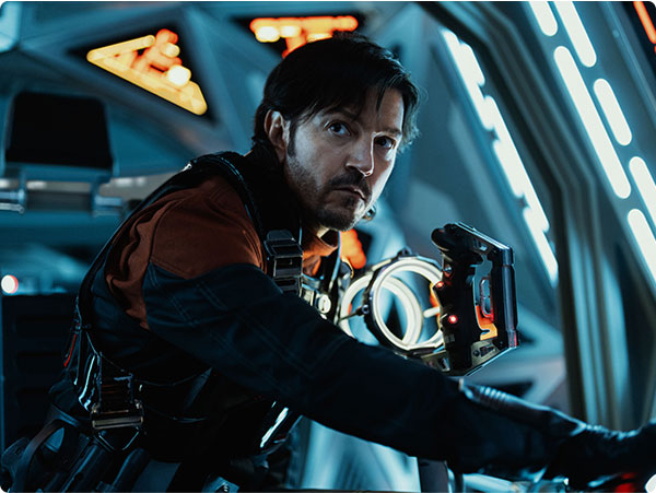 A close-up of Cassian Andor in a spaceship cockpit, intensely focused in a scene from Star Wars series Andor.
