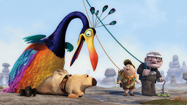 Kevin the bird, Dug the dog, Russel, and Carl Fredricksen stand together in the wilderness in a heartfelt moment from Up. 