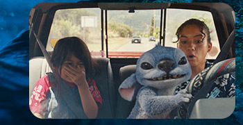 Inside a pickup, Stitch grabs the steering wheel while the driver gasps and a girl in back covers her giggles