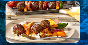 Hawaiian-style plates of glazes meatball-and-veggie skewers served over white rice.