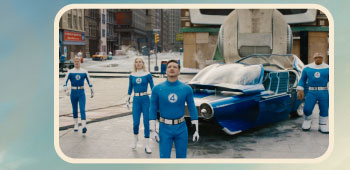 Four figures in blue Fantastic 4 uniforms stand around a white-and-blue prototype car on a city street.