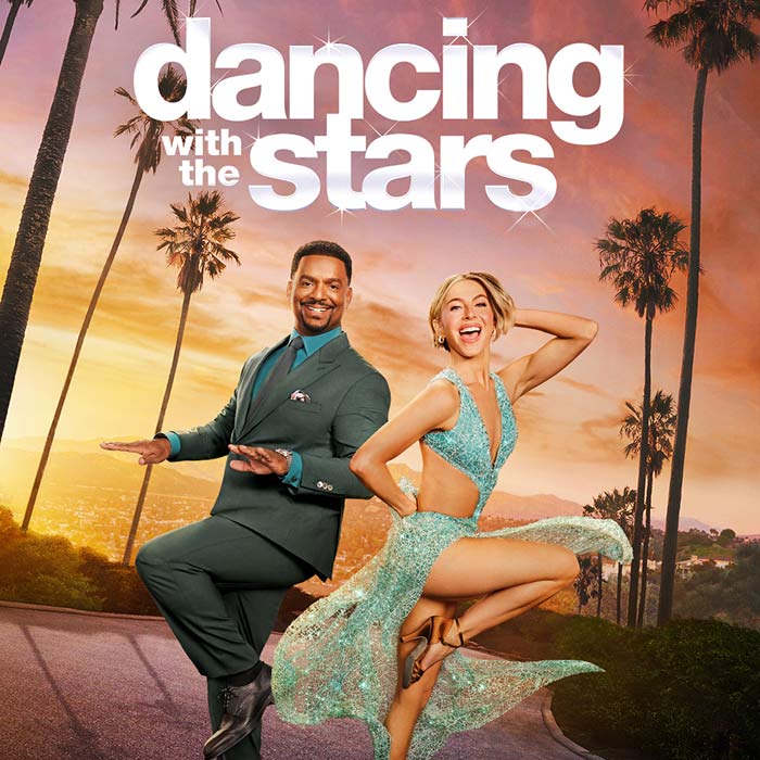 Dancing with the Stars with Alfanso Ribeiro in suit and Julianne Hough in glittering teal dress posing against sunset skyline.