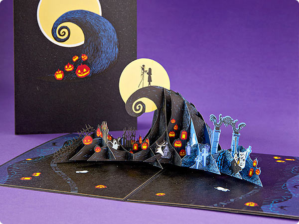 Nightmare Before Christmas pop-up book scene with Jack and Sally on spiral hill under moonlight.