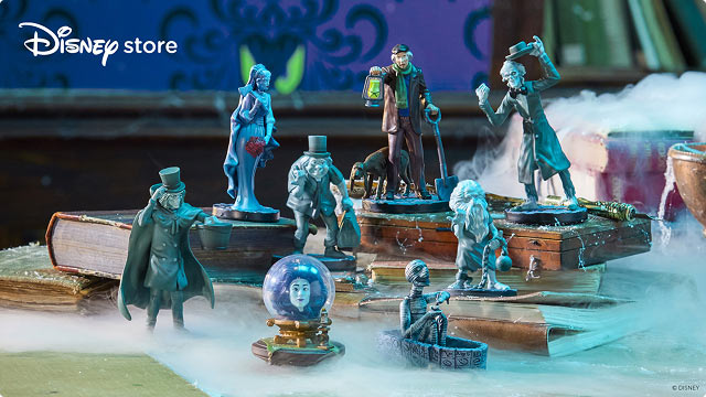 Disney Store Haunted Mansion figurines including Hitchhiking Ghosts, Madame Leota, and other characters on display.