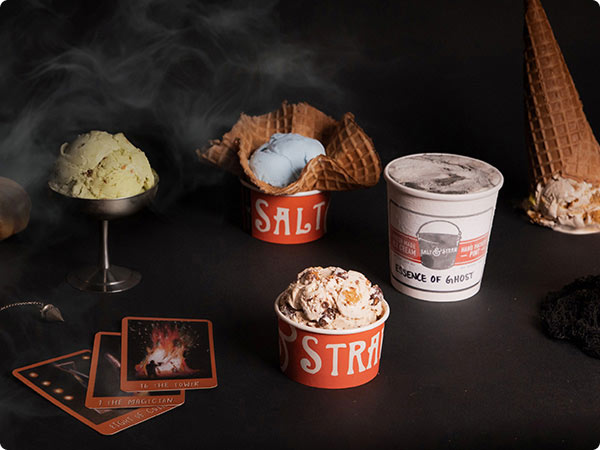 Salt & Straw ice cream displays with waffle cones, cups, and smoky Halloween atmosphere.