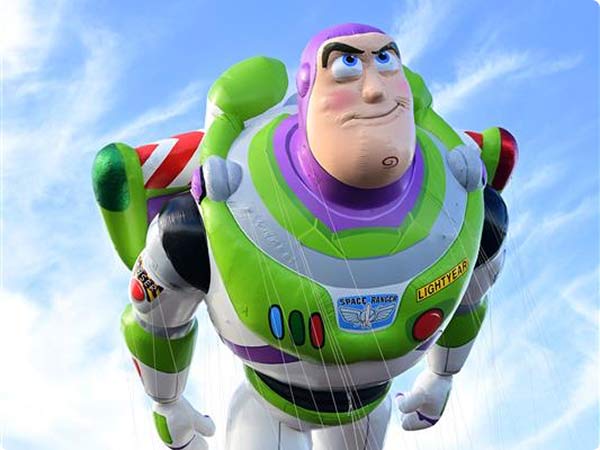 Buzz lightyear from Toy Story flying upward against a bright sky, looking determined.