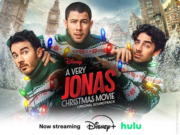 The Jonas Brothers wrapped in Christmas lights for the ‘A Very Jonas Christmas Movie’ soundtrack, now streaming on Disney+ and Hulu.