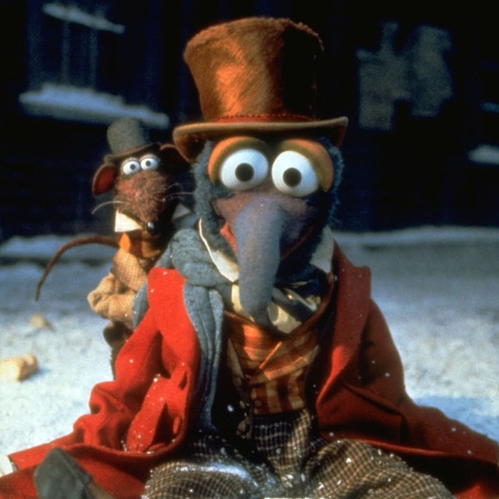 Gonzo and Rizzo in Victorian outfits during a snowy holiday scene.
