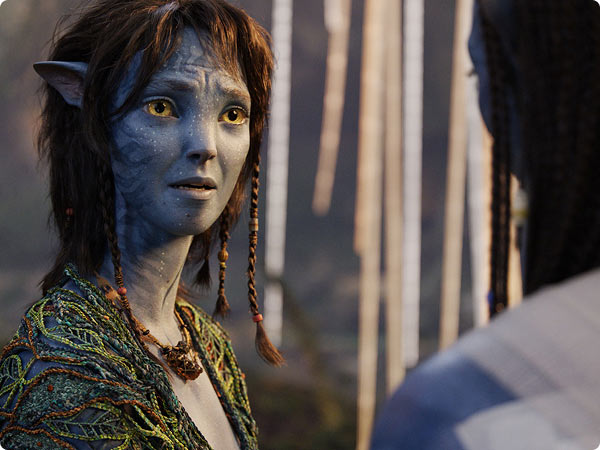 Kiri from Avatar looks emotional during a quiet forest moment.