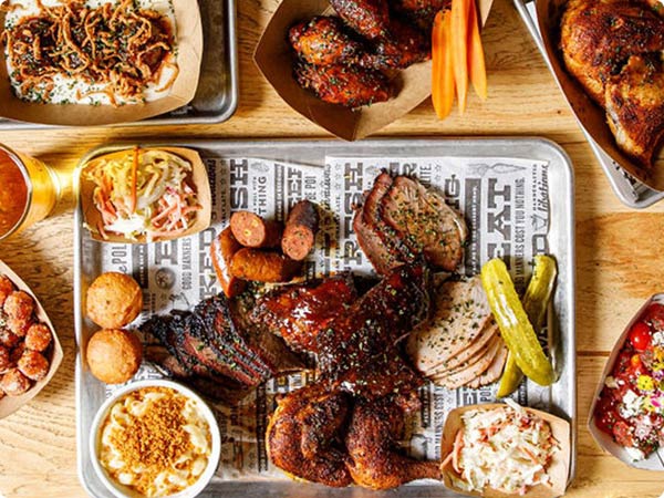 The Polite Pig barbecue platter with ribs, sausages, sides, and cornbread at Disney Springs Fl.