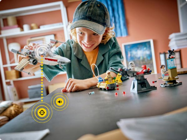 Child playing with the first LEGO Star Wars play set. Includes a spacecraft and character builds.